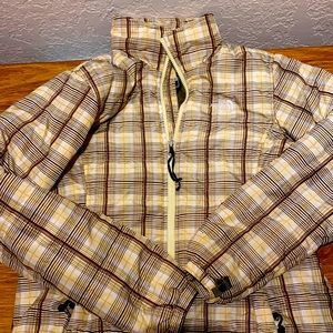 Women’s medium  yellow tan brown and white striped north face winter jacket.